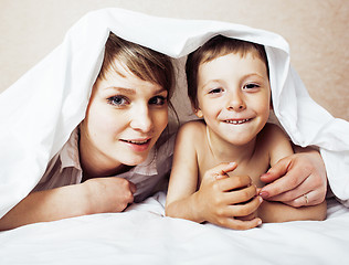 Image showing young blond woman with little boy in bed, mother and son, happy 