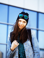 Image showing young pretty girl near business building walking