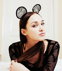 Image showing young pretty brunette woman wearing sexy lace mouse ears, laying