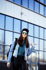 Image showing young pretty girl near business building walking