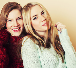 Image showing Two young girlfriends in winter sweaters indoors having fun. Lif