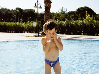 Image showing little cute real boy in swimming pool close up smiling