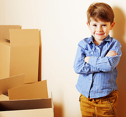 Image showing little cute boy in empty room, remoove to new house. home alone,