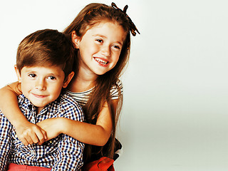 Image showing little cute boy and girl hugging playing on white background, ha