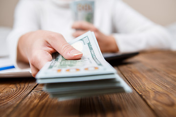 Image showing Hands of person proposing money to you - closeup shot