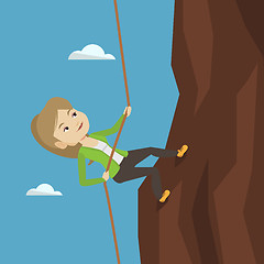Image showing Business woman climbing on the mountain.