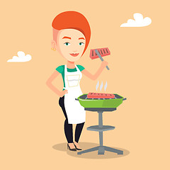 Image showing Woman cooking steak on barbecue grill.