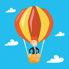 Image showing Young woman flying in hot air balloon.