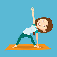 Image showing Woman practicing yoga triangle pose.