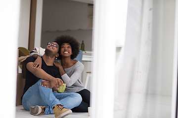 Image showing African American couple relaxing in new house