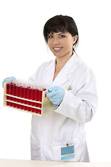 Image showing Female carrying rack of test tubes