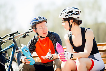 Image showing Cyclists in helmets with water