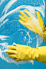 Image showing Man washes window in gloves