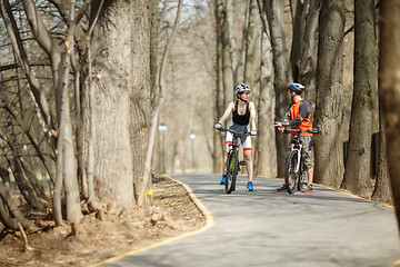 Image showing Young cyclists drive around park