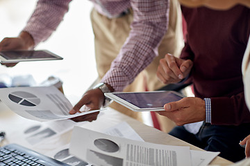 Image showing businessmen with tablet pc and charts at office