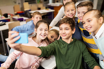 Image showing group of school kids taking selfie with smartphone