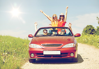 Image showing happy friends driving in cabriolet car at country