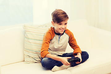 Image showing happy boy with joystick playing video game at home