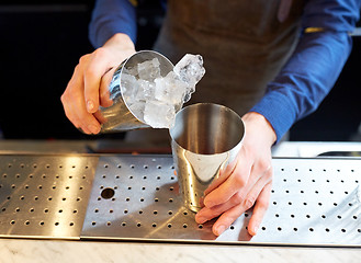 Image showing bartender with ice and shaker at cocktail bar