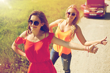 Image showing women with broken car hitchhiking at countryside