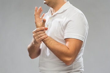 Image showing close up of man suffering from pain in hand