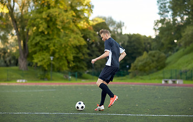 Image showing soccer player playing with ball on football field