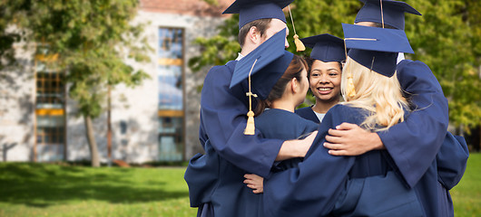 Image showing happy students or bachelors hugging