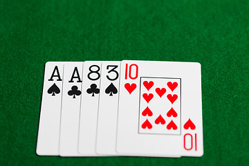 Image showing poker hand of playing cards on green casino cloth