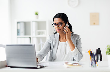 Image showing businesswoman with laptop and smartphone at office