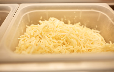 Image showing container with grated cheese at restaurant kitchen