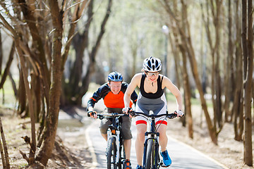 Image showing Two cyclists ride on road
