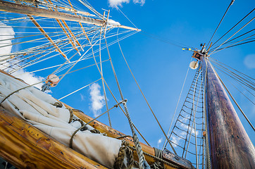 Image showing Folded sail and mast on an old sailboat