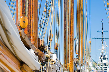 Image showing Folded sail and mast on an old sailboat