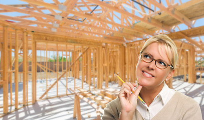 Image showing Pensive Woman with Pencil On Site Inside New Home Construction F