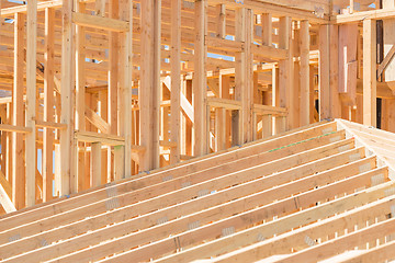 Image showing Wood Home Framing Abstract At Construction Site.