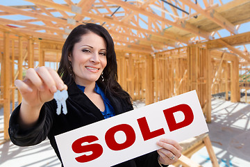 Image showing Hispanic Woman With Keys and Sold Sign On Site Inside New Home C