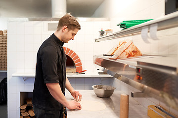 Image showing chef preparing pizza dough in kitchen at pizzeria