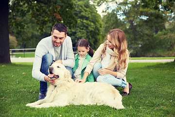 Image showing happy family with labrador retriever dog in park