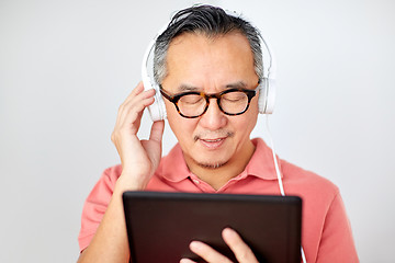 Image showing man with tablet pc and headphones