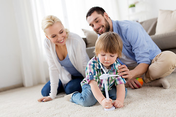 Image showing happy family playing with toy wind turbine