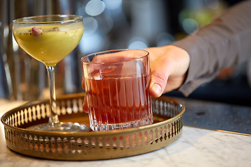 Image showing bartender with glasses of cocktails at bar