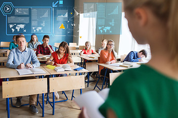 Image showing group of students and girl with notebook at school