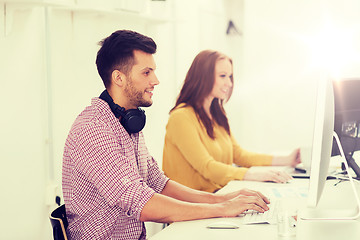 Image showing creative team with headphones and computer