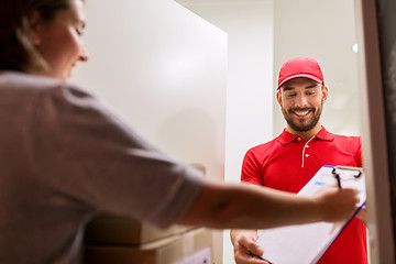 Image showing deliveryman and customer with parcel boxes at home