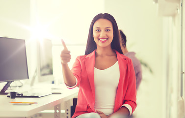 Image showing happy african woman showing thumbs up at office