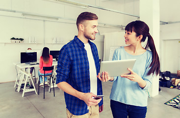 Image showing couple with smartphone and tablet pc at office