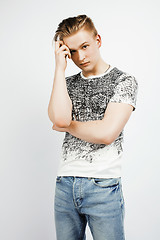 Image showing young handsome teenage hipster guy posing emotional, happy smiling against white background isolated, lifestyle people concept closeup