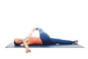 Image showing Woman doing Yoga asana Revolved knee-to-chest Pose isolated