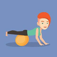 Image showing Young woman exercising with fitball.