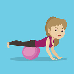 Image showing Young woman exercising with fitball.